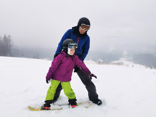 Fototapeta na wymiar snowboard lesson in winter resort