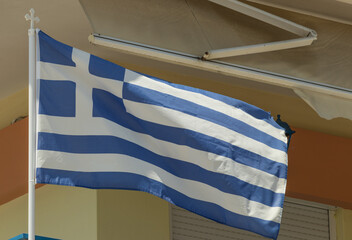 The Greek flag flutters in the wind 