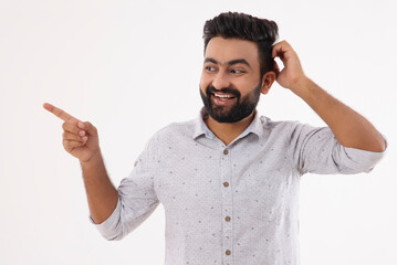 A HAPPY BEARDED MAN STANDING AND POINTING AWAY