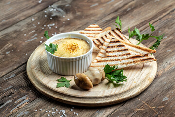 Julienne with mushrooms in creamy sauce, julienne. Bechamel sauce and cheese baked in glass Mini Baking cup with grilled toasts. Restaurant menu, dieting, cookbook recipe