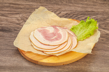 Sliced Pancetta sausage over board