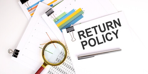RETURN POLICY , text on white paper on the light background with charts paper