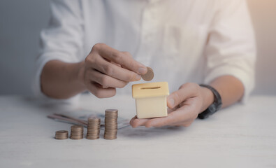 House Model and Coins Stacks on desk,Save and investment money for prepare in the future,Saving money concept