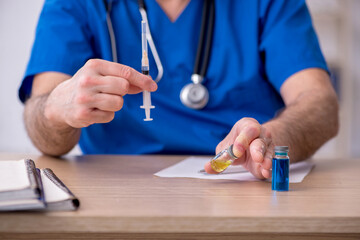Old male doctor in vaccination concept