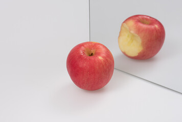 Apple reflecting in the mirror ,Cheating concept
