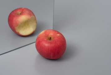 Apple reflecting in the mirror ,Cheating concept