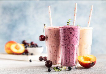 Colorful various smoothie or milkshake with assorted ingredients served in glasses with straw....