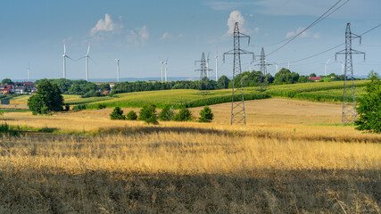 Rural landscape with wind turbines and electric lines in Poland