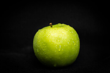Wet Green Apple on Black Background