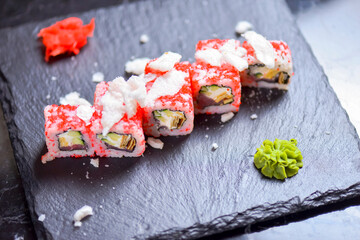 Sushi roll Philadelphia with salmon, tuna, avocado, cream cheese, passion fruit sauce. Sushi menu. Japanese food.