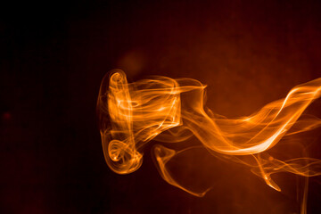 Gold smoke on black background.