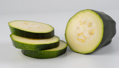 fresh green zucchini slices isolated on white background.