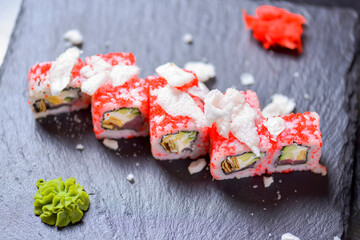 Sushi roll Philadelphia with salmon, tuna, avocado, cream cheese, passion fruit sauce. Sushi menu. Japanese food.