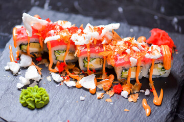 Sushi roll Philadelphia with salmon, tuna, avocado, cream cheese, passion fruit sauce. Sushi menu. Japanese food.