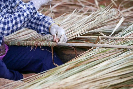 Selective Focus Grandma's Hand Is Building A Roof Hay Roof Natural House Roof In A Rural Village In Thailand