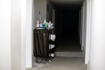 Cleaning utility janitorial cart in hotel corridor