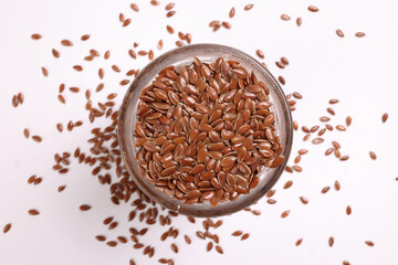 Flex seed flaxseed closeup in small glass jar bottle sprinkled seeds top view