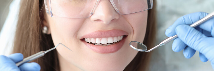 Portrait of smiling woman with beautiful white teeth at dentist appointment