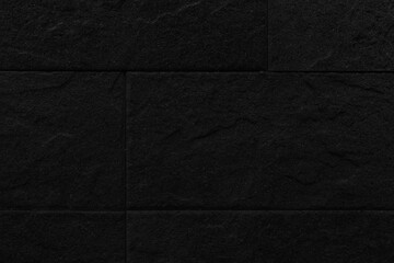 Fototapeta premium Black granite tiled wall with vintage pattern texture and background seamless