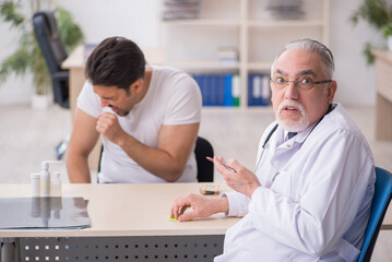 Young male patient visiting old male doctor