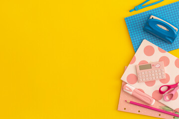 School stationery on a yellow background. Top view with copy space. Flat lay. Back to school concept.