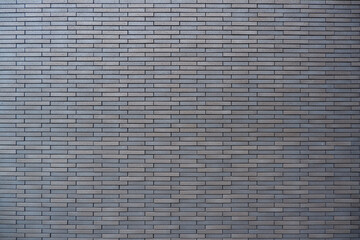 Modern gray brick background. Brick surface for design. Design background material. Vintage, wallpaper, interior, exterior elements
