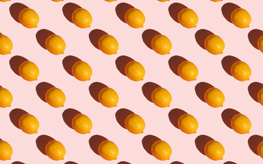 Flat lay composition with fresh ripe lemons on light pink background. Banner. Top view