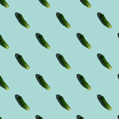Fresh cucumbers on a blue background. Pattern of cucumbers. Top view. Banner. Pop art design, creative summer food concept. Green cucumbers, minimal flat lay style.