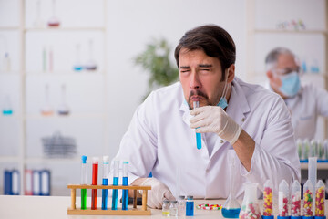 Two male chemists in drugs synthesis concept at the lab