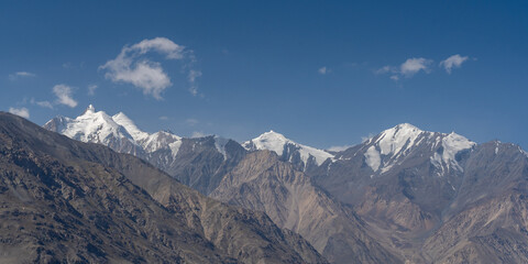 Scenic panoramic view on snow capped Hindu Kush mountain range peaks on Afghanistan side of Wakhan corridor, Gorno-Badakshan, Tajikistan
