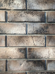 Stone Brick cladding wall background, Vertical photo of grey modern brick exterior wall. Sun light.