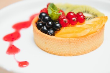 Delicious cheesecake with berries on table close up