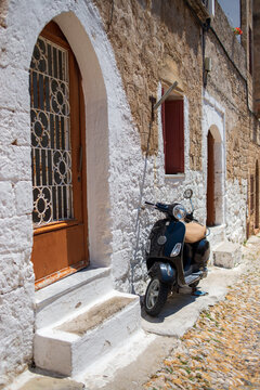 old scooter in front of a house