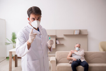 Young male doctor visiting old patient in vaccination concept