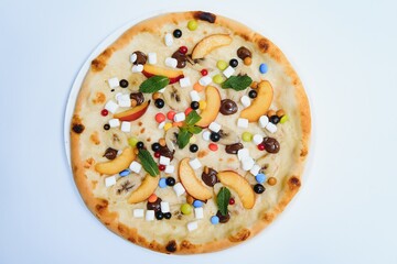 Sweet pizza with marshmallow sauce and colored sweets, chocolate pizza with colored sweets and chocolate pizza with banana on a white background