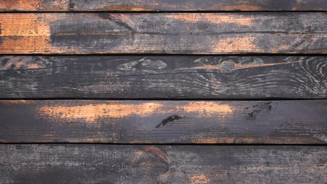 Close-up top view flatlay 4k stock video footage of old used vintage tool. Man puts old rusty axe on weathered wooden surface background