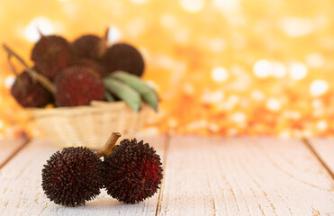 A couple of the local fruits called pulasan, a tropical fruit from soapberry family, similar to rambutan. Selective focus. Blurred background