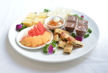 cold sweet dessert platter with pudding, mango, fruits, deep fried red bean paste, jelly, strawberry, watermelon, almond, longan, lychee in white background asian halal menu