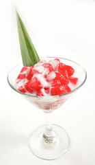 chilled red ruby dessert with coconut milk sauce in cocktail glass in white background asian halal menu