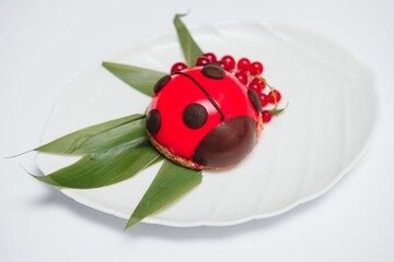 Design cake in the form of ladybug on a white background