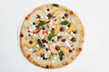 Sweet pizza with marshmallow sauce and colored sweets, chocolate pizza with colored sweets and chocolate pizza with banana on a white background