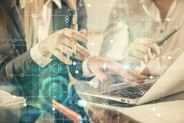 Double exposure of man and woman working together and technology theme drawing hologram. Big data concept. Computer background.
