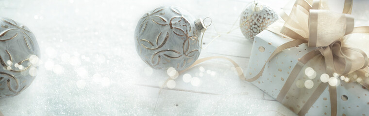 Christmas with white ornament in frosty winter and festive bokeh on white wooden planks. Winter and...