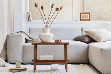 Creative composition of stylish living room interior with grey corner sofa, window, wooden coffee...