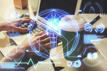 Double exposure of woman hands typing on computer and general theme hologram drawing. Education concept.