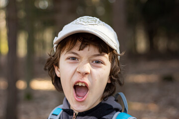 Portrait of screaming boy outdoor. © Cornel