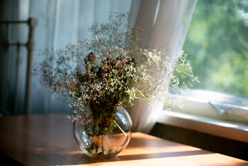 dry still life of a bouquet of wildflowers on the table in the morning in a vintage interior