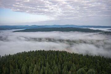 Aerial view on mountains in clouds from drone