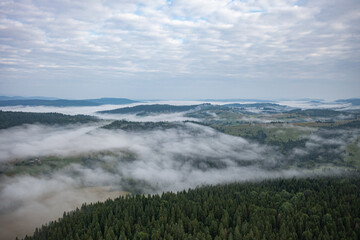 Aerial view on mountains in clouds from drone