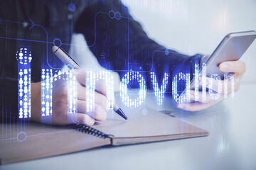 Double exposure of technology sketch hologram and woman holding and using a mobile device.